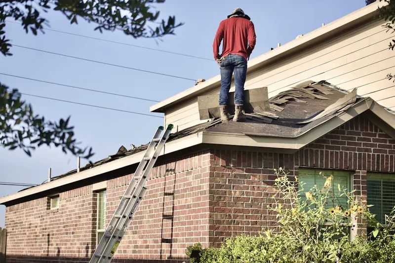 Professional roofer working on a residential roof in Timberwood Park